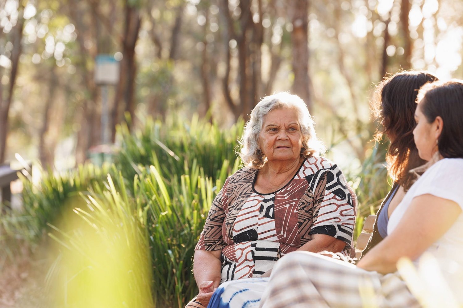Women from different generations sitting together and talking.